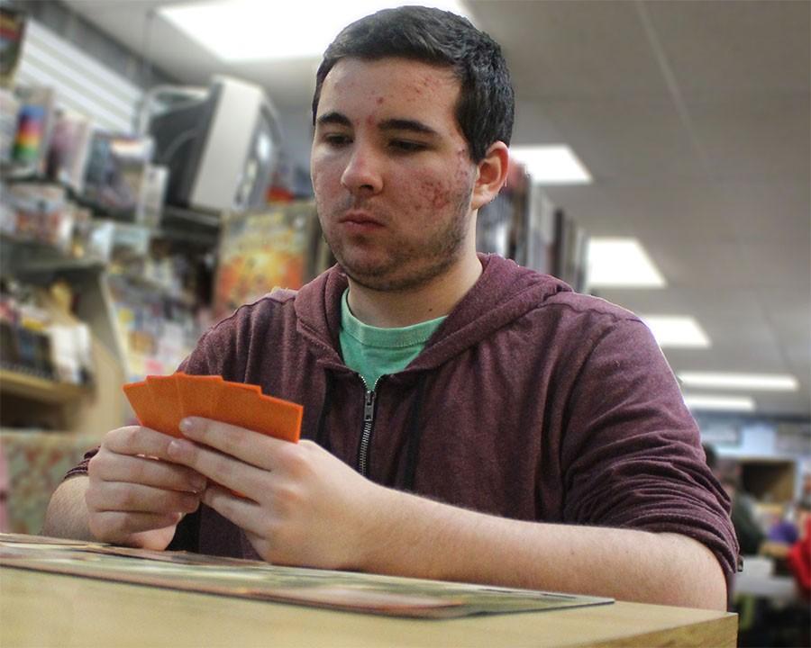 Josh Lane, senior, considers his cards during a game of Magic.