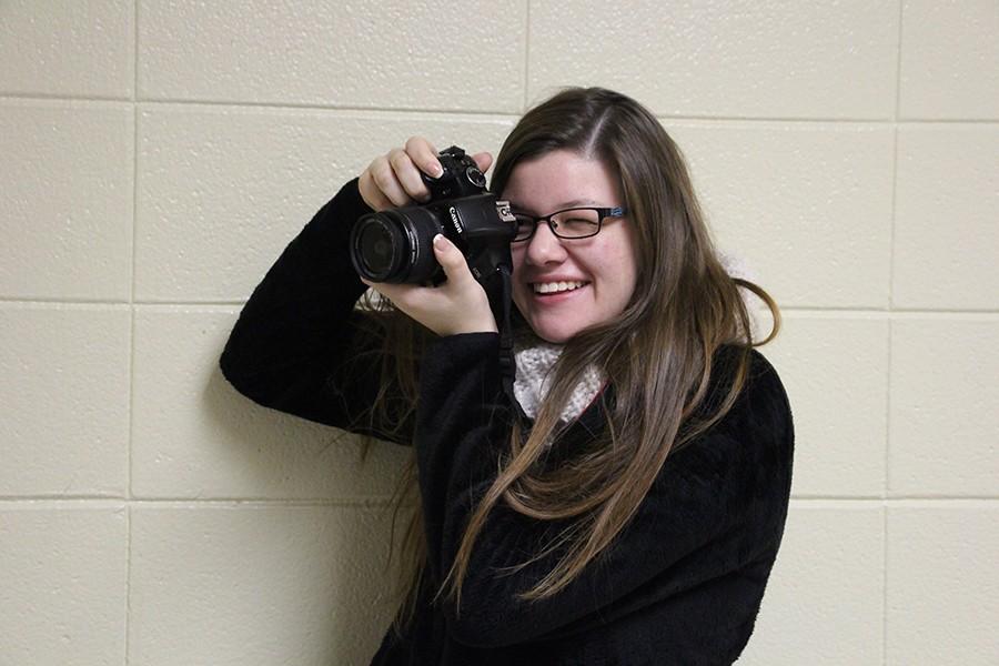 Hope Hill, senior,  poses with her camera, ready to take pictures.  Hill has been taking pictures for two to three years. She has been able to capture many moments with her trusty camera. 