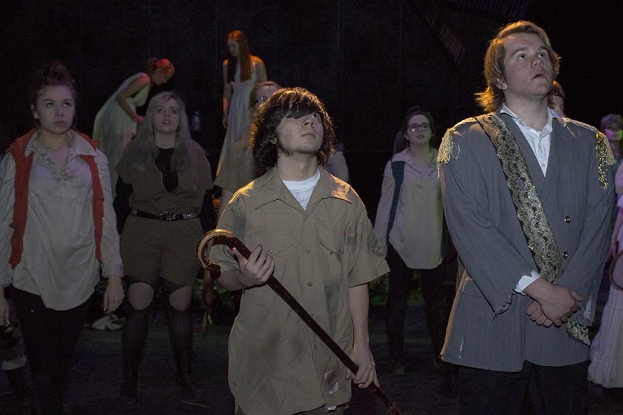 Curtis Leonard, senior, and John Stecher, junior, perform onstage during “Antigone.” The show featured an in-your-face experience for the audience as it told the story of Antigone as she tries to bury her brother.  “Antigone” offered a different experience for many in the audience. 