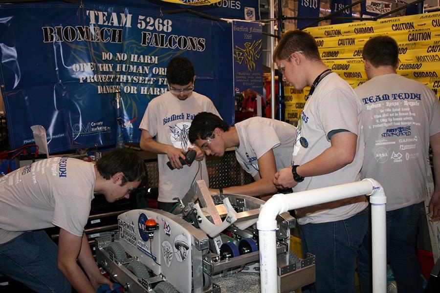 (Left to right)Ryan Mersmann, senior; Jaden Nuber, junior; Nathan Helgeson, senior; Brett Hale, junior; working on the robot.