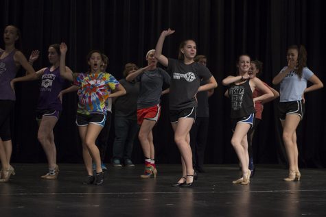 The cast of the fall play work on their blocking and dancing.