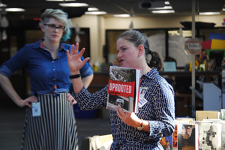Kate McNair, a librarian at Johnson County Library, and Angela Parks, a librarian at Olathe Public library, giving short synopsises of new books at an event during seminar on April 7.