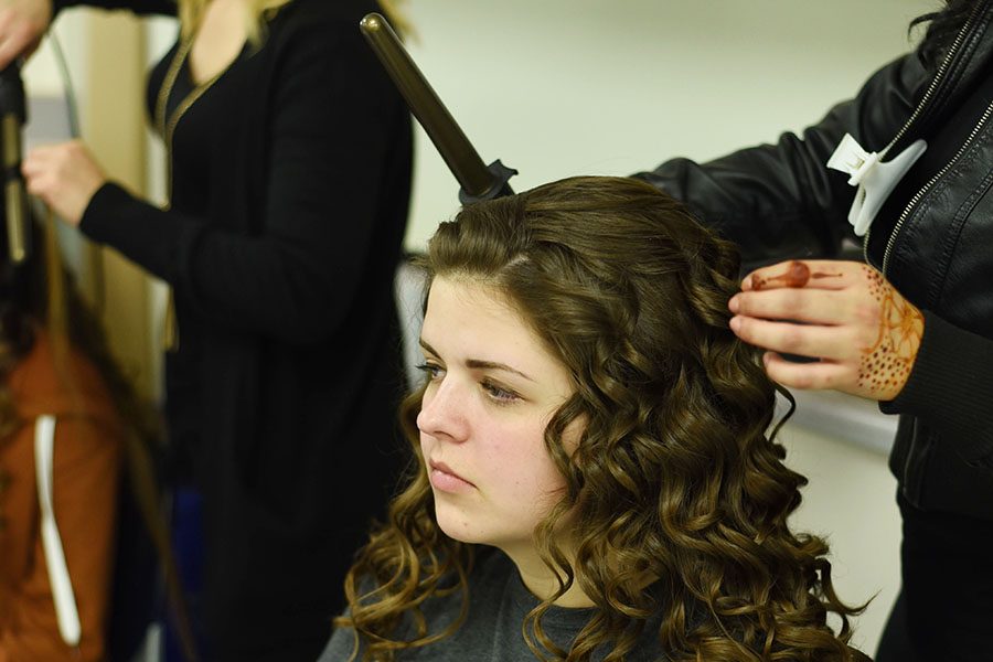 Lally Pribyl, senior, gets her hair done before the fashion show.
