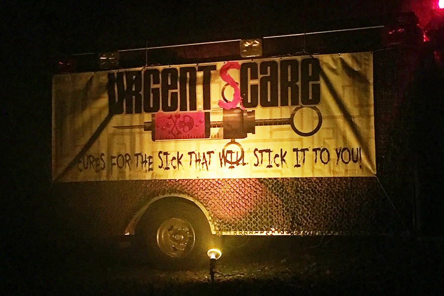 Staff members went to Worlds of Fun and attended multiple haunted houses. This photo was taken outside of the haunted house, Urgent Scare. It features a bus near the line to the haunted house. The quotation on the side of the bus says “cures for the sick that will stick it to you” with a needle above the quotation.