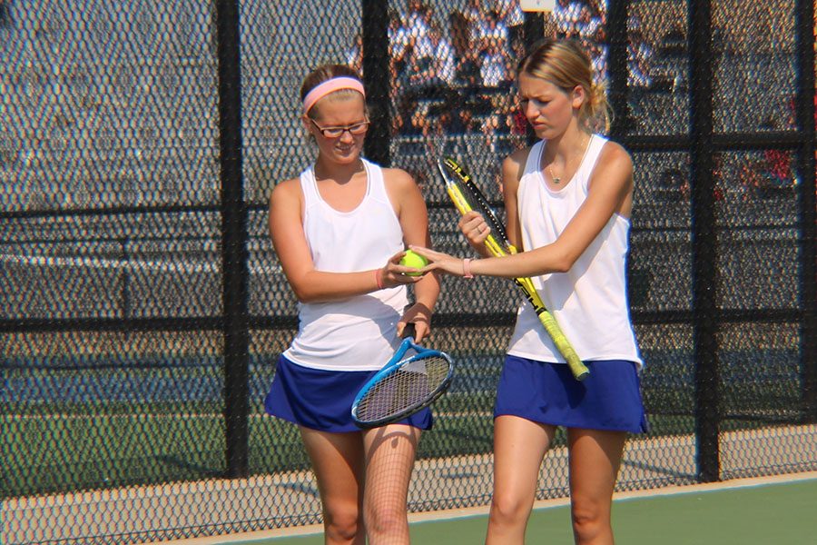Captains of the girls tennis team Rylee Zuck and Emma Bundy get prepared for their match.