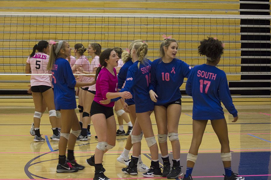 The volleyball team groups up at the Dig Pink game. The game was held in support of Breast Cancer Awareness Month.  The team hoped to raise $10,000 for a non-profit organization called Side Out Foundation. Along with holding a raffle, the team accepted donations and sold their jerseys in an effort to raise even more money. Dr. Alison Banikowski, retired deputy superindent, spoke at the banquet before the game happened about how to check oneself for breast cancer.
