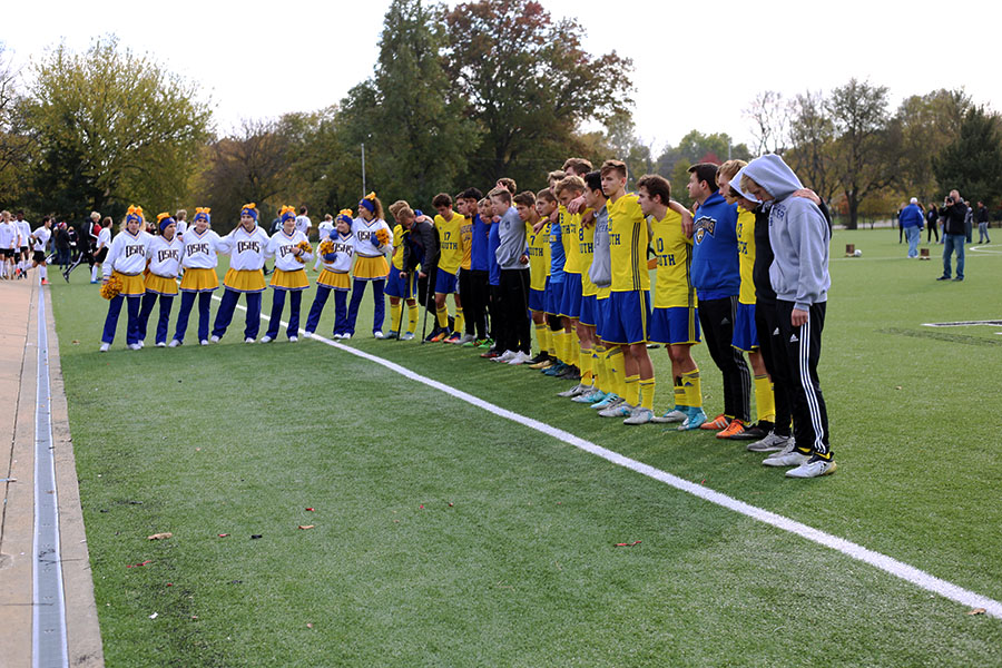 The boys soccer team lines up to sing the alma mater after the state soccer game against Blue Valley West. The team got second place in the 6A state championship.
