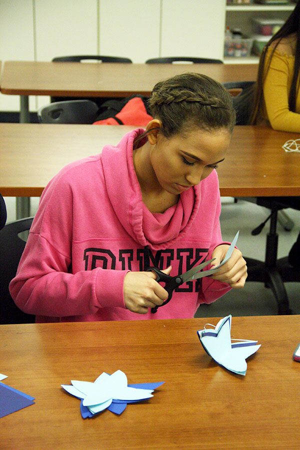 Ariana Harland is cutting out butterflies for fashion showcase.