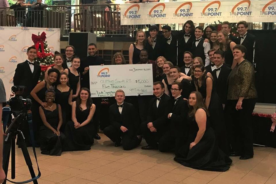 Choir students celebrated with a picture after finding out they won the competition.