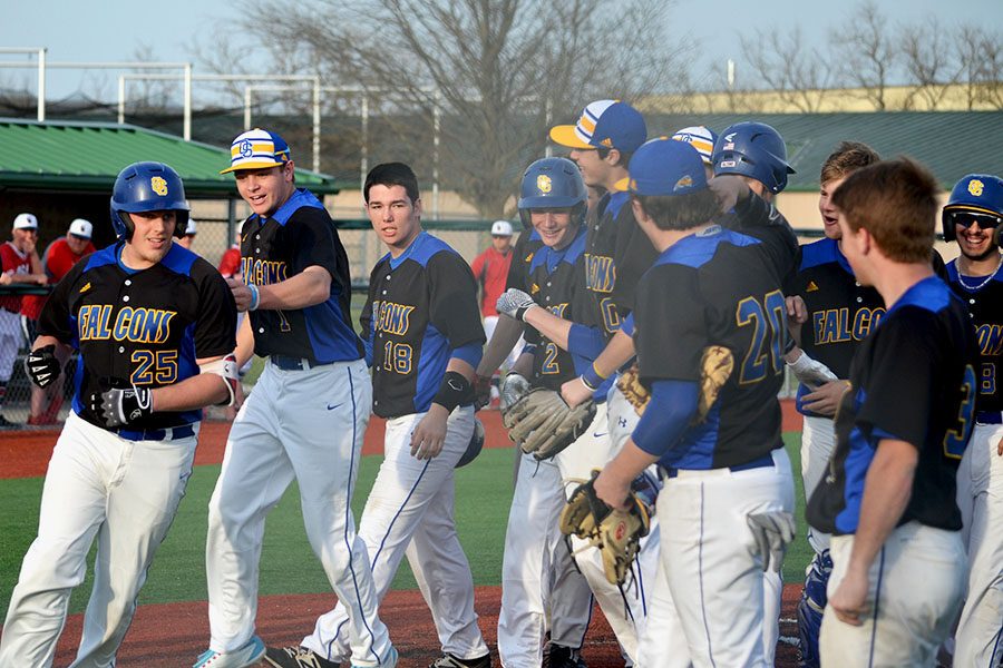 The baseball team returns to the dugout after celebrating a home run against Olathe North. It was announced on March 18 that there would be no fireworks this year, however, as all spring sports have been canceled in their entirety.