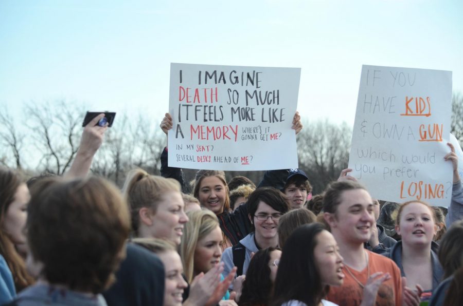 Maddie Smith, senior, holds up a sign during protest. 